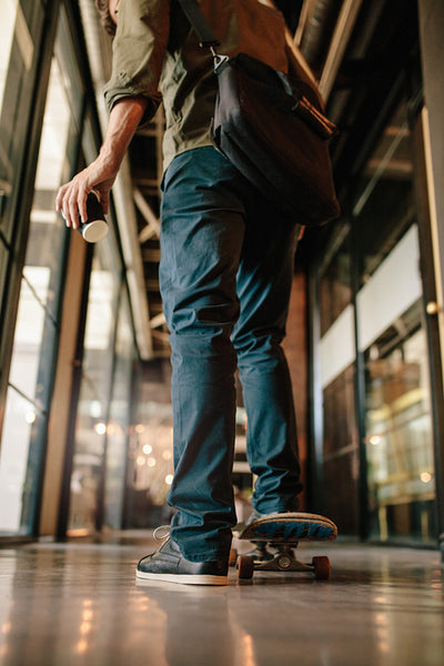 Man with skateboard in office