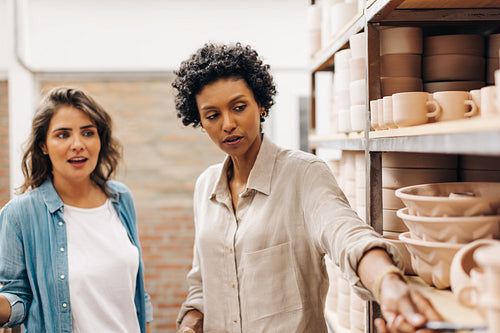 Ceramic shop owners having a discussion in their store