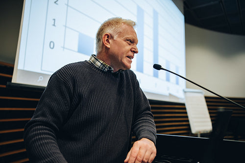 Senior businessman giving presentation during a seminar