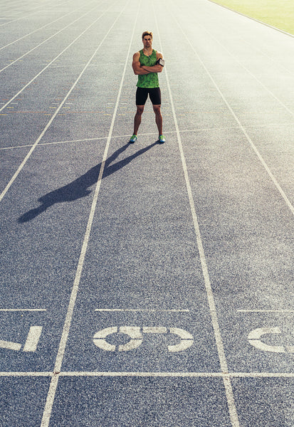 Sprinter standing on running track