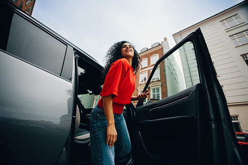On a downtown street, the woman makes her arrival from the car
