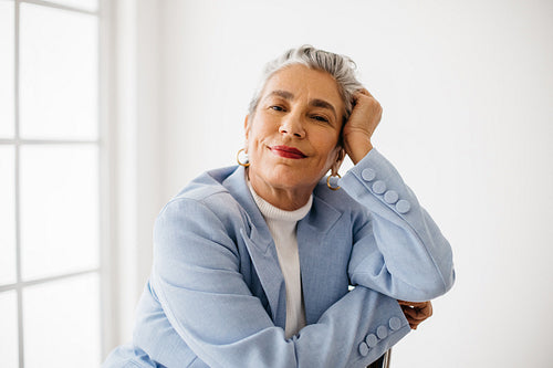 Confident in her capabilities: Mature business woman looking at the camera in a suit