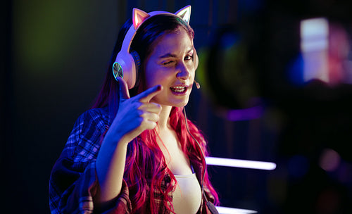 Catch you later: Female gamer recording a vlog in front of a camera