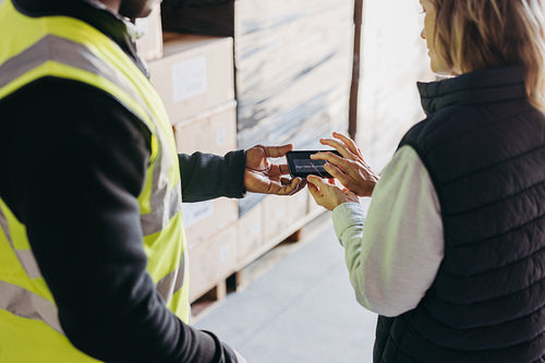 Female warehouse manager e-signing a dock receipt after receiving a delivery
