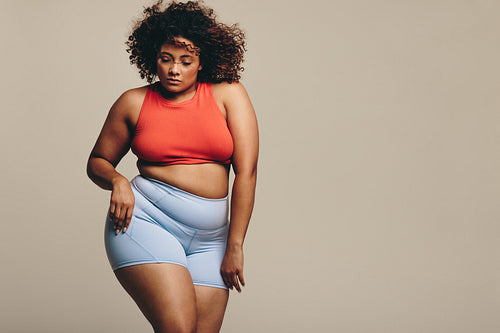 Confident young woman moving her fit and flexible body in a studio