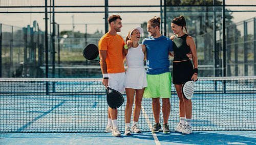 Winning moments: Athletes standing together on padel tennis court