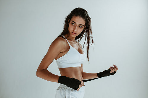 Female boxer wrapping hands