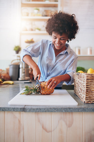 Young african woman working at juice bar