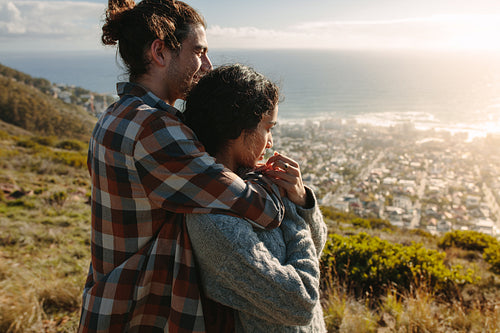 Romantic couple admiring a view from cliff