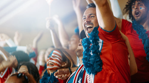 American soccer fans cheering their team in stadium