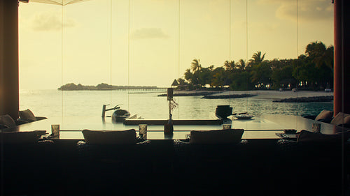 Tropical luxury resort dining area with an incredible ocean view at sunset or sunrise