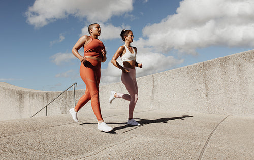 Two women jogging together
