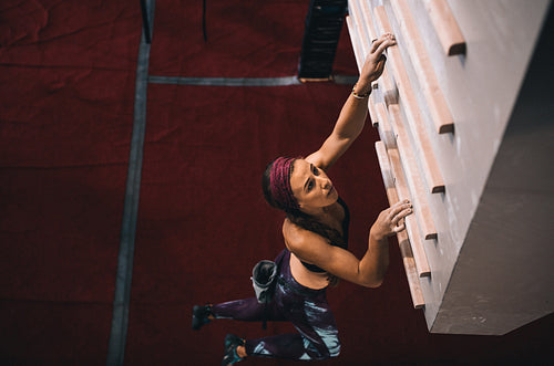 Woman training on a campus board