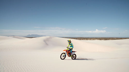 Motorcyclist doing a wheelie in a desert