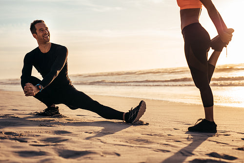 Runners doing warm-up before running at the beach