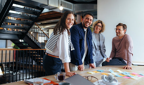 Advertising professionals smiling in a meeting. Business people brainstorming in an office