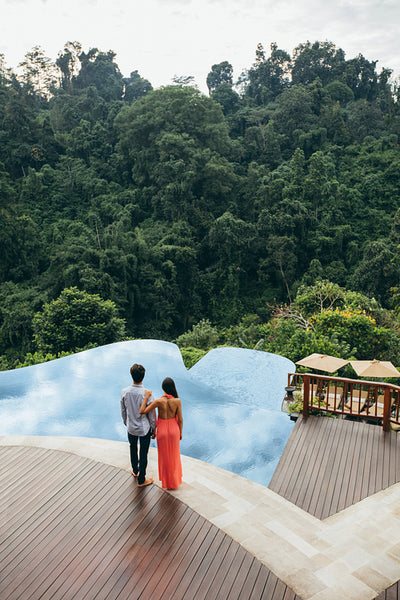 Young couple standing by a swimming pool