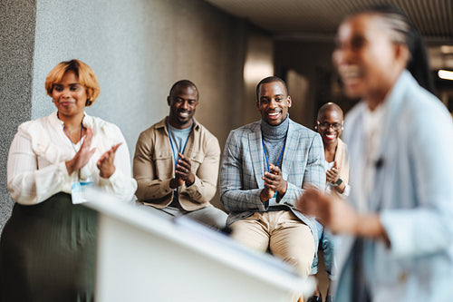 Business audience clapping for speaker at a professional seminar