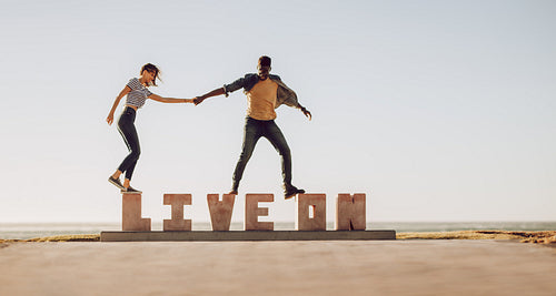 Friends walking over a LIVE ON word