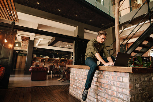 Creative professional working on laptop in cafe