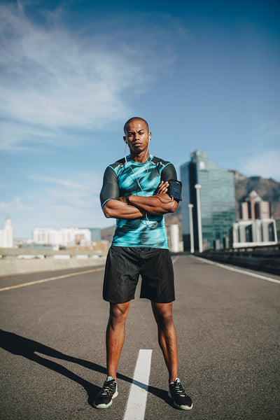 Urban male runner standing on the street