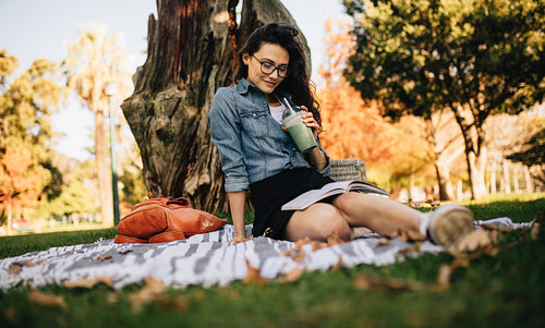 Relaxed woman reading a book in park