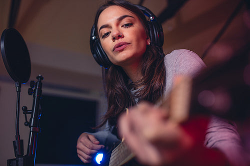 Guitarist playing guitar in a recording studio