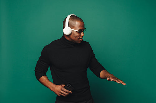 Modern man enjoying music in a stylish studio setting