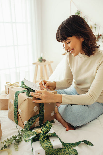 Smiling woman writing a letter for christmas
