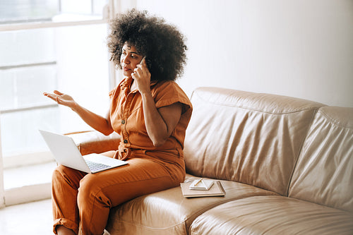 Businesswoman speaking on the phone in an office lobby