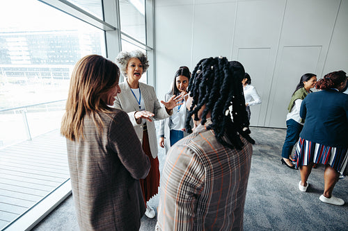 Diverse group of business professionals networking and engaging at a corporate event