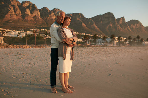 Romantic senior couple embracing on the sea shore