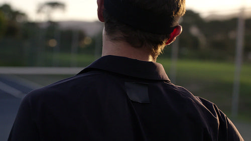 Tennis player checking his racket on the hard court