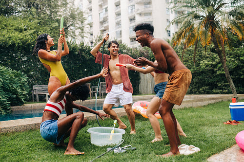 Friends enjoying a lively backyard pool party