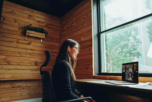 Happy businesswoman having a video call in a coworking space
