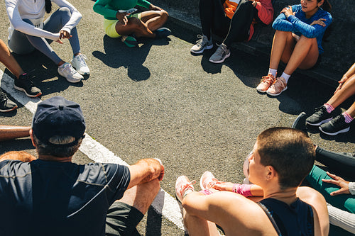 Running club members gathered for a pre-race meeting outdoors