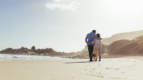 Romantic couple walking on the beach