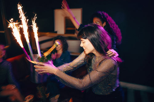 Celebratory event with champagne and sparklers in a festive nightclub atmosphere