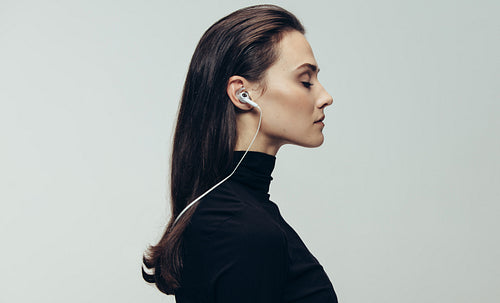 Woman in black with earphones