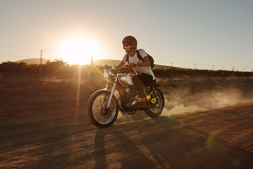 Man offroading on a vintage motorcycle