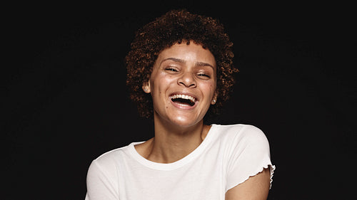 Happy young woman with curly hair