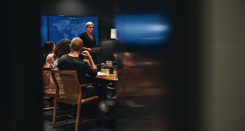 Caucasian Businesswoman addressing staff in a meeting
