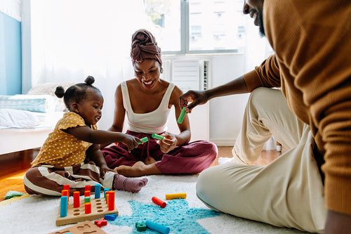 Family playtime at home with parents and child