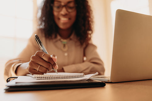 Businesswoman working from home on laptop