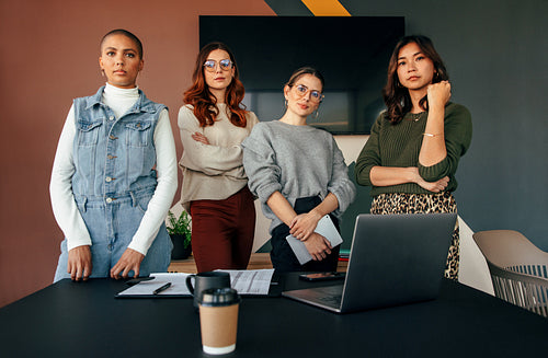 Group of female entrepreneurs standing in a boardroom