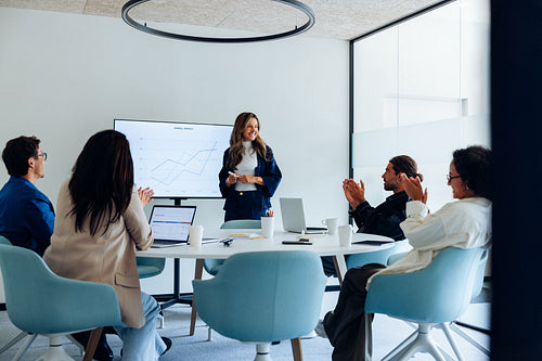 Woman presents UX design findings to team