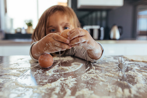 Little girl learning cooking in the kitchen