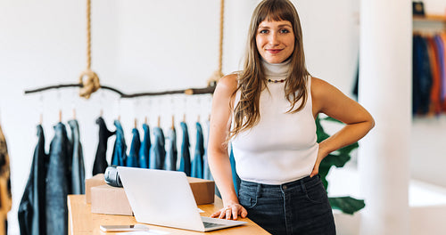 Female business owner looking at the camera in her shop