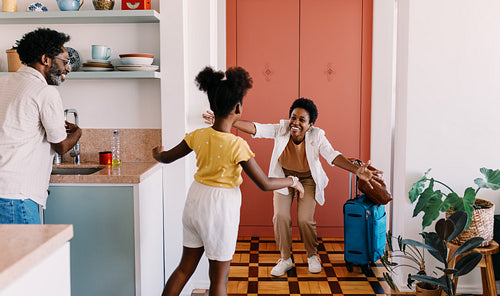 Family reunion: Mother greeting her daughter with a hug after a trip