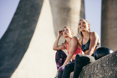 Fitness females relaxing outdoors after workout
